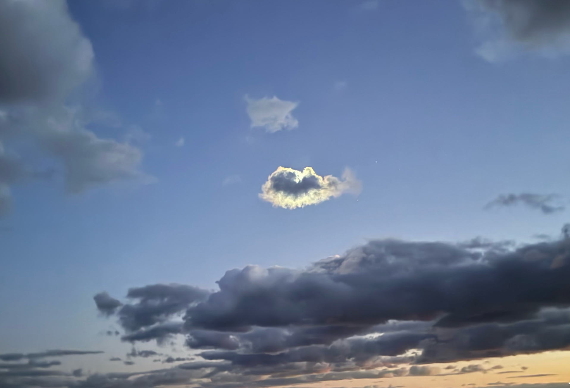 A heart-shaped cloud in a night sky.